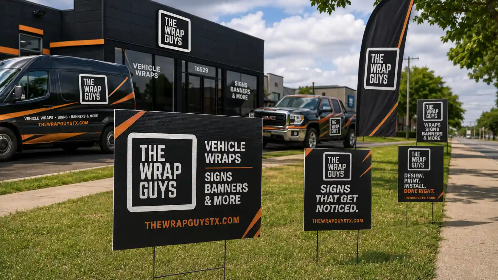 The Wrap Guys branded coroplast yard signs displayed outside a sign and wrap shop